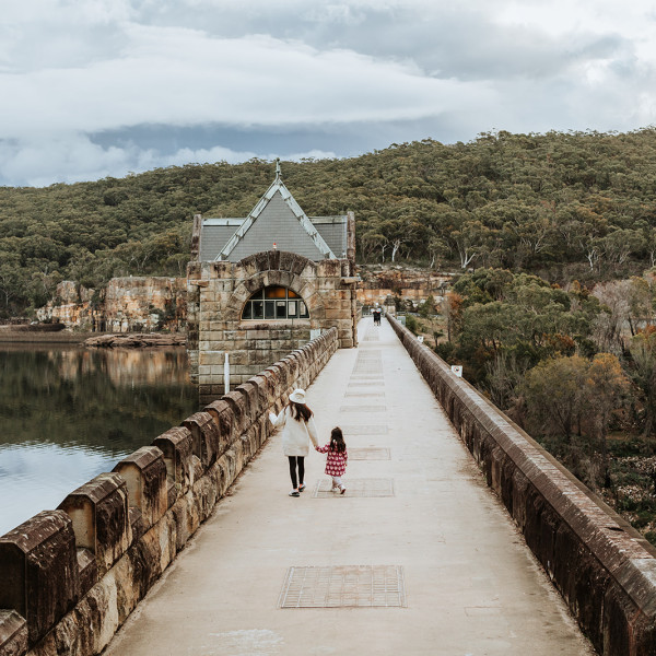 Mother and Daughter walking across Cataract Dam Wall